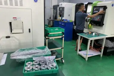 Master machinist performing precision CNC turning for custom engineering components.