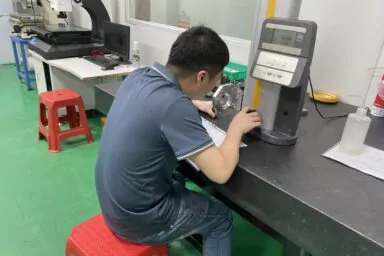 Quality technician using height gauge to ensure ±0.01mm tolerance for precision parts